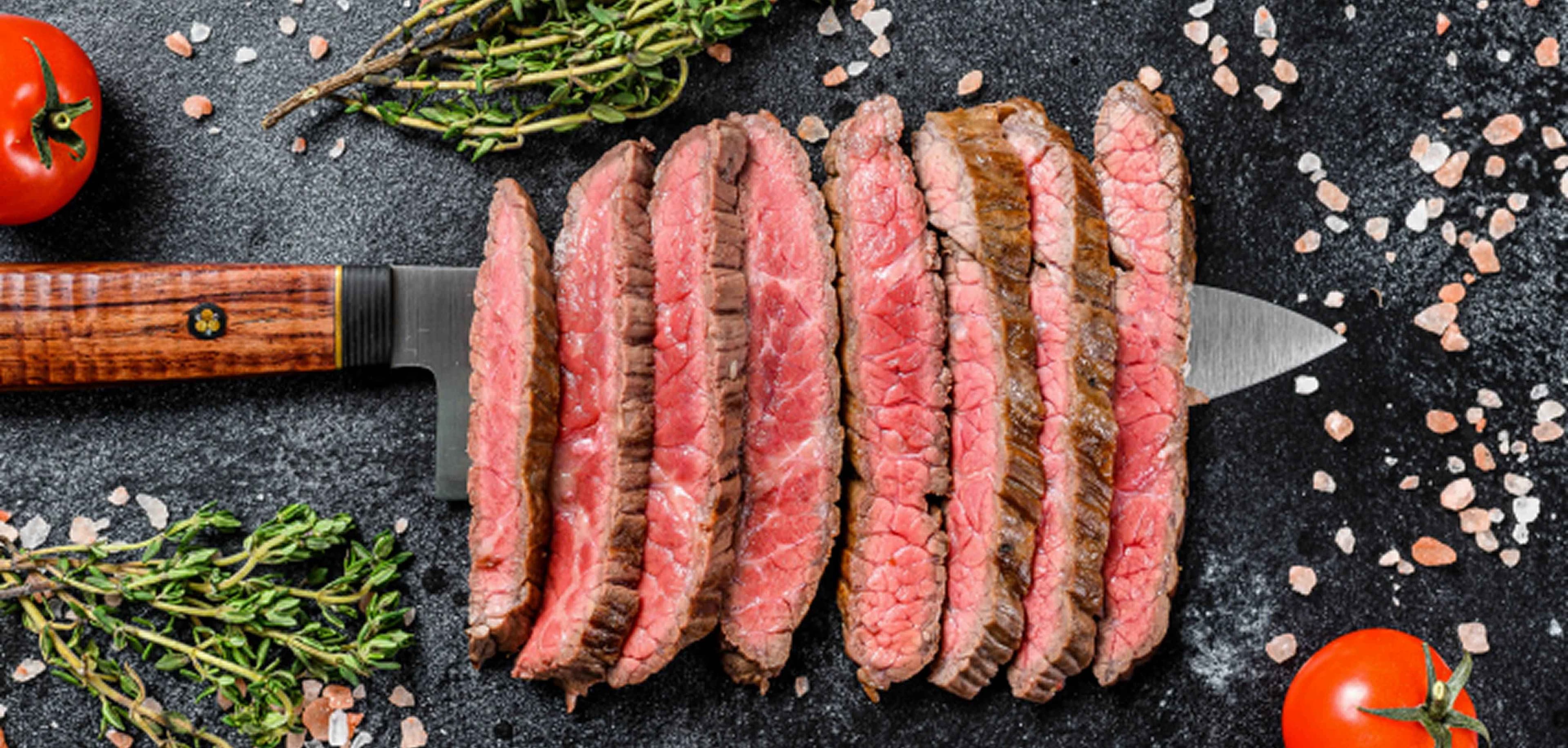 Bord met premium vleesgerechten bereid op de houtskoolgrill bij Colony Grill